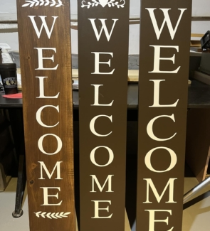 3 wood signs welcome